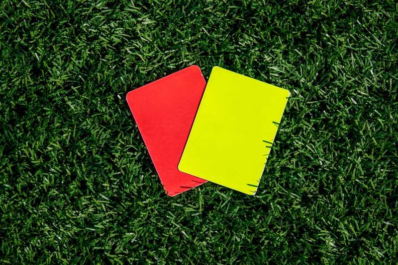 Football Red and Yellow Cards on Grass